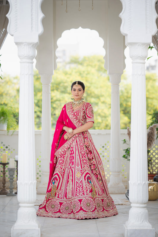 A stunning hot pink silk bridal lehenga featuring peacock motifs kardana sequins zardozi and pearl work lehenga beautifully adorned with fine craftsmanship and exquisite detailing, perfect for festive and special occasions.