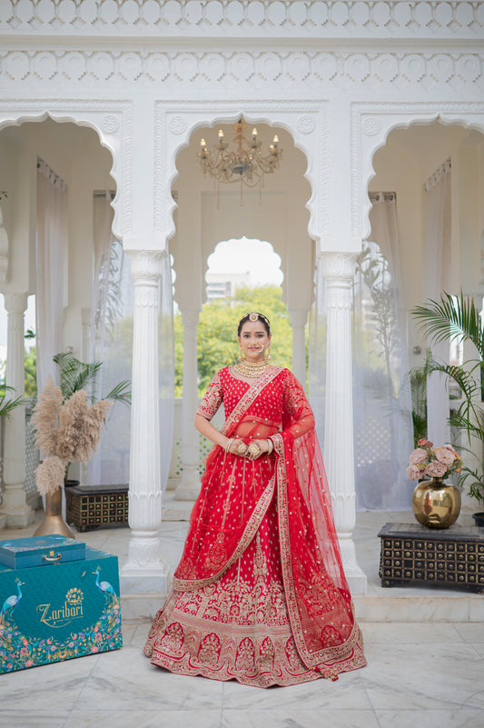 A stunning red silk bridal lehenga featuring aari sequins work lehenga beautifully adorned with fine craftsmanship and exquisite detailing, perfect for festive and special occasions.