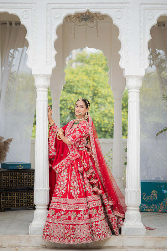 A stunning red silk bridal lehenga featuring embroidery aari sequins pearl work lehenga beautifully adorned with fine craftsmanship and exquisite detailing, perfect for festive and special occasions.