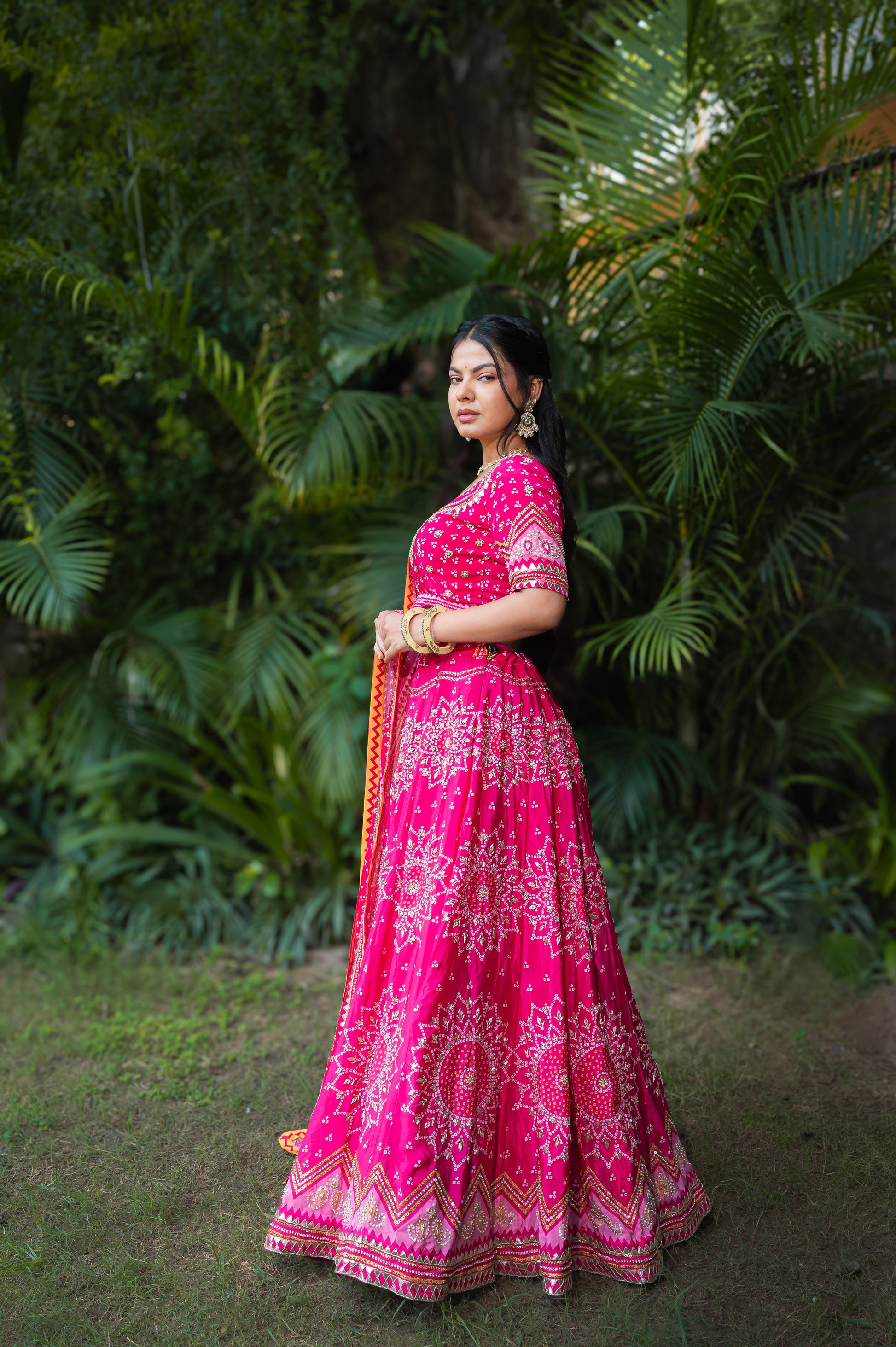 A stunning dark hot pink silk bandhej lehenga featuring zardozi and sequins work lehenga beautifully adorned with fine craftsmanship and exquisite detailing, perfect for festive and special occasions.