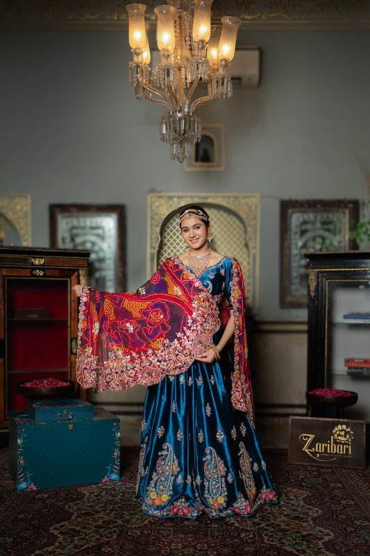 A stunning red pure ojariya bandhej chunari featuring marodi zardozi sequins gota patti work chunari beautifully adorned with fine craftsmanship and exquisite detailing, perfect for festive and special occasions.