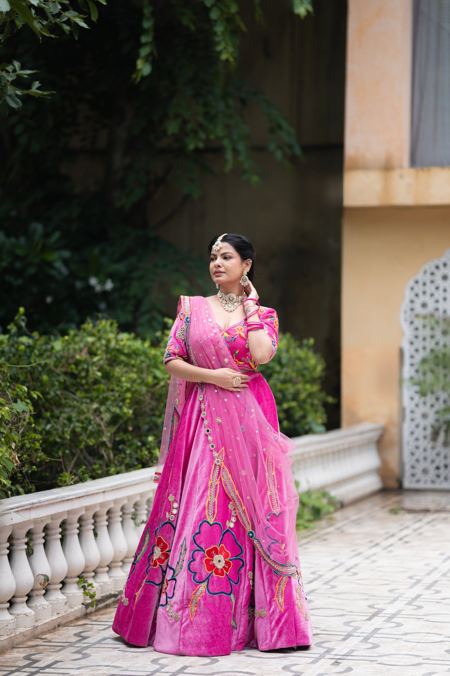 A stunning purplish pink pure velvet lehenga featuring zardozi thread flower motifs work lehenga beautifully adorned with fine craftsmanship and exquisite detailing, perfect for festive and special occasions.