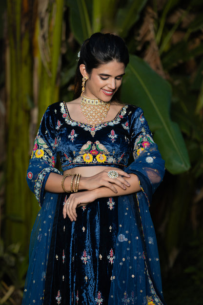 A stunning navy blue velvet lehenga featuring zardozi thread flower and moti work lehenga beautifully adorned with fine craftsmanship and exquisite detailing, perfect for festive and special occasions.
