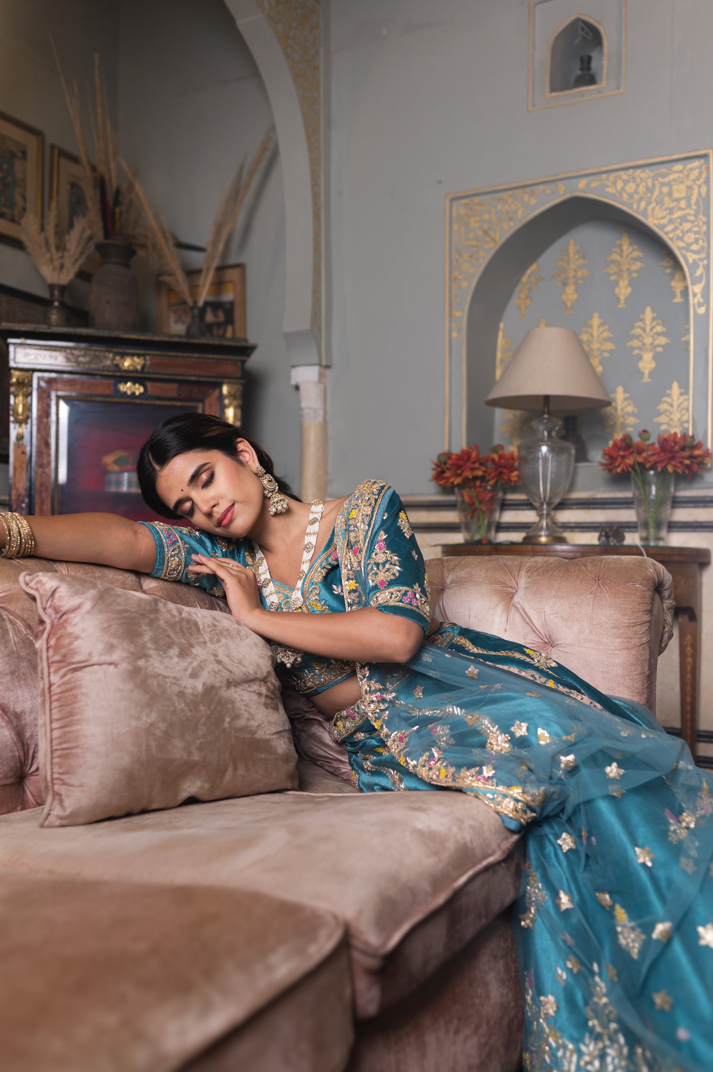 A stunning sea blue velvet lehenga featuring zardozi and moti work lehenga beautifully adorned with fine craftsmanship and exquisite detailing, perfect for festive and special occasions.