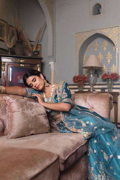 A stunning sea blue velvet lehenga featuring zardozi and moti work lehenga beautifully adorned with fine craftsmanship and exquisite detailing, perfect for festive and special occasions.