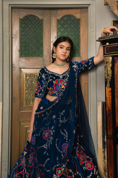 A stunning navy blue velvet lehenga featuring zardozi thread and moti work lehenga beautifully adorned with fine craftsmanship and exquisite detailing, perfect for festive and special occasions.
