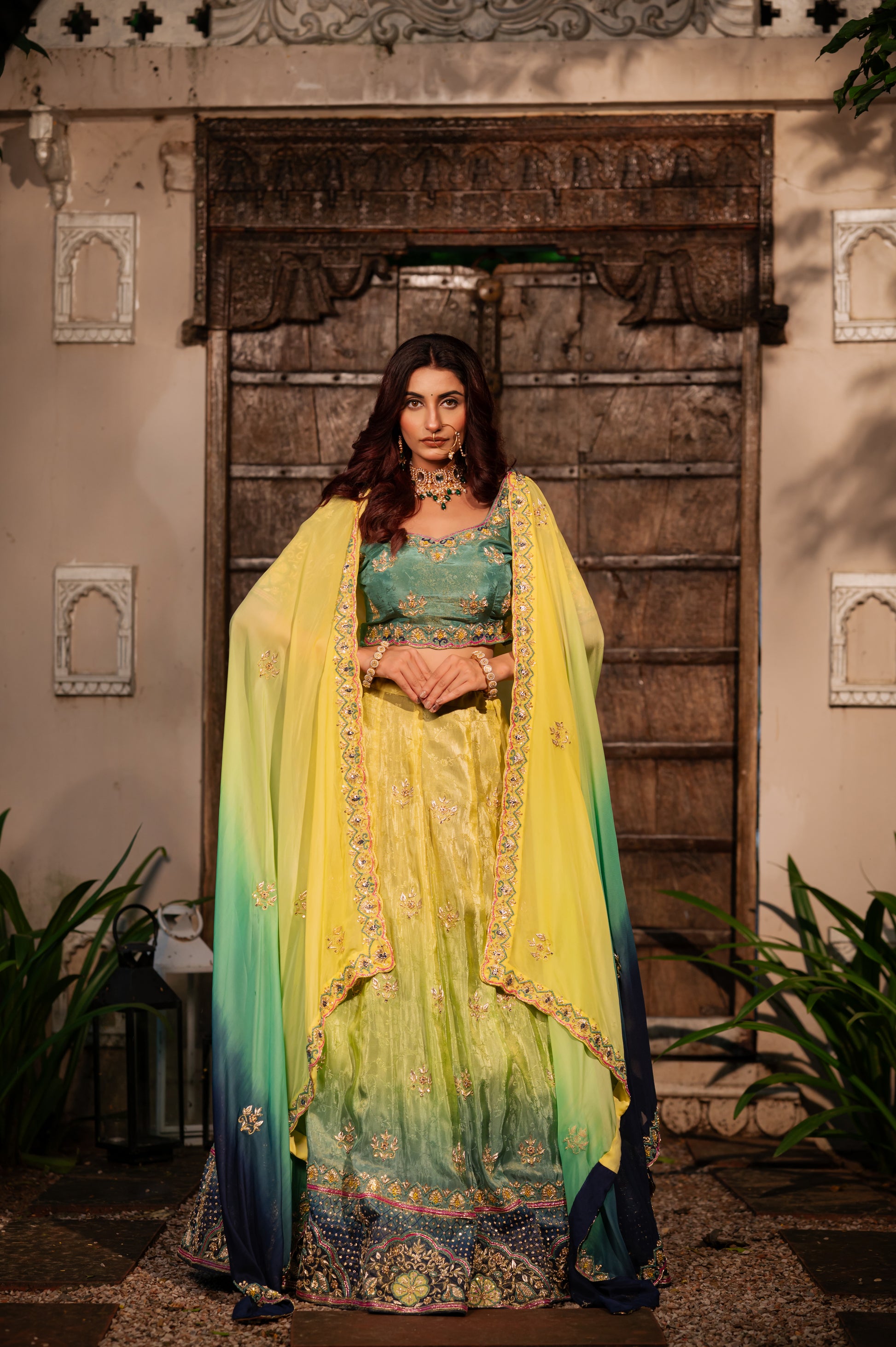 A stunning yellow parrot green shaded crepe lehenga featuring zardozi sequins kardana work lehenga beautifully adorned with fine craftsmanship and exquisite detailing, perfect for festive and special occasions.