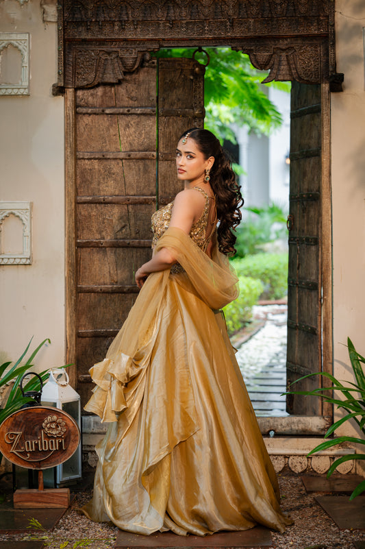 A stunning coffee golden tissue satin lehenga featuring zardozi sequins work lehenga beautifully adorned with fine craftsmanship and exquisite detailing, perfect for festive and special occasions.