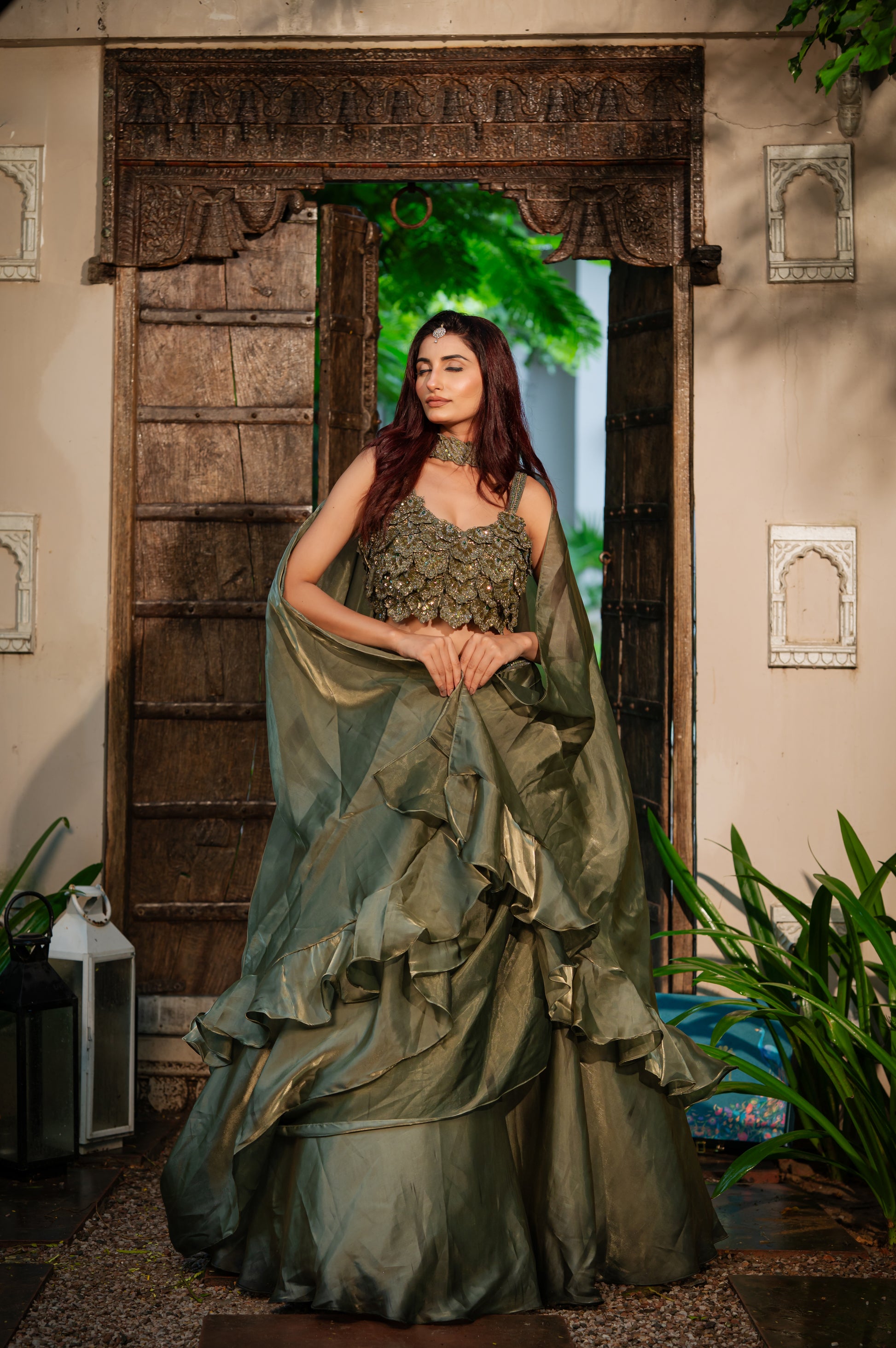 A stunning olive tissue satin lehenga featuring zardozi sequins work lehenga beautifully adorned with fine craftsmanship and exquisite detailing, perfect for festive and special occasions.