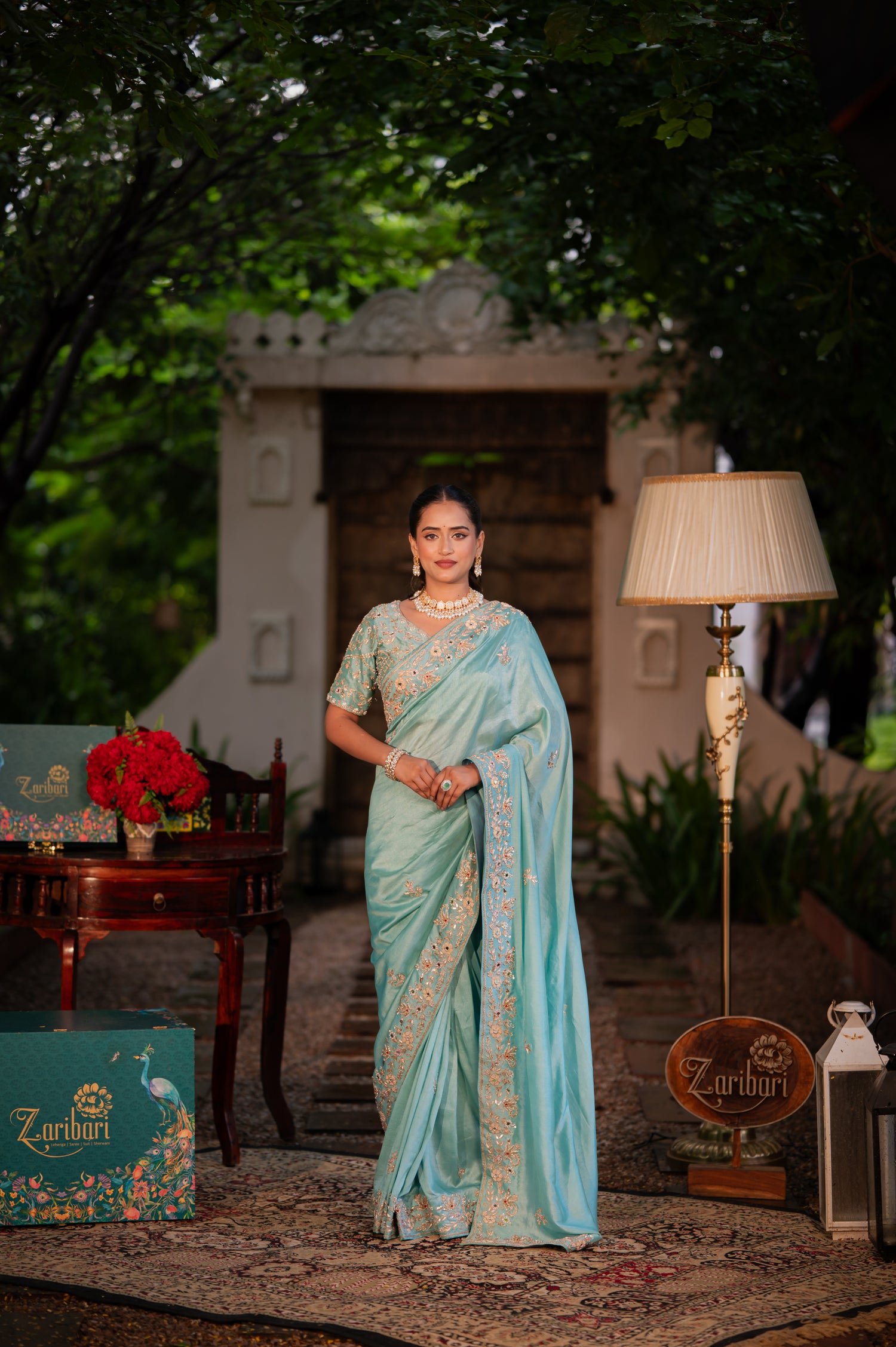 A stunning morning blue pure silk saree featuring aari zardozi and gota patti work saree beautifully adorned with fine craftsmanship and exquisite detailing, perfect for festive and special occasions.