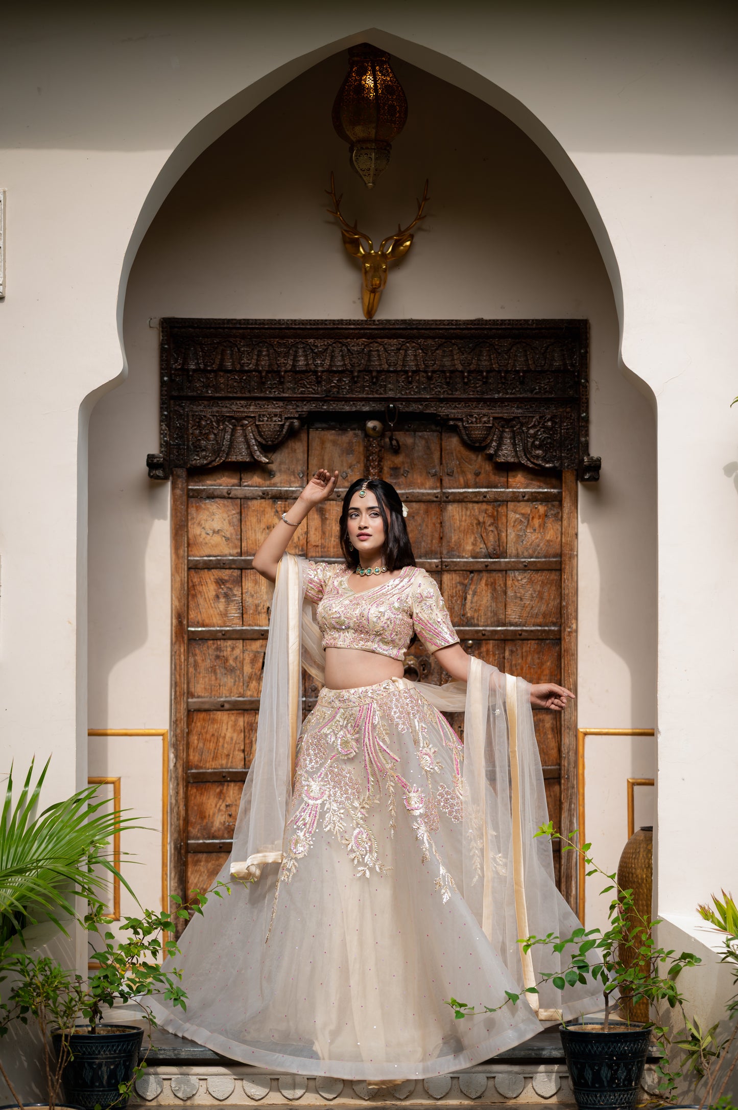 A stunning light grayish orange net lehenga featuring sequins work lehenga beautifully adorned with fine craftsmanship and exquisite detailing, perfect for festive and special occasions.