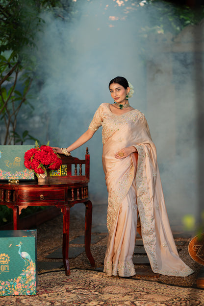 A stunning beige sand raw silk saree featuring aari zardozi gota patti work saree beautifully adorned with fine craftsmanship and exquisite detailing, perfect for festive and special occasions.