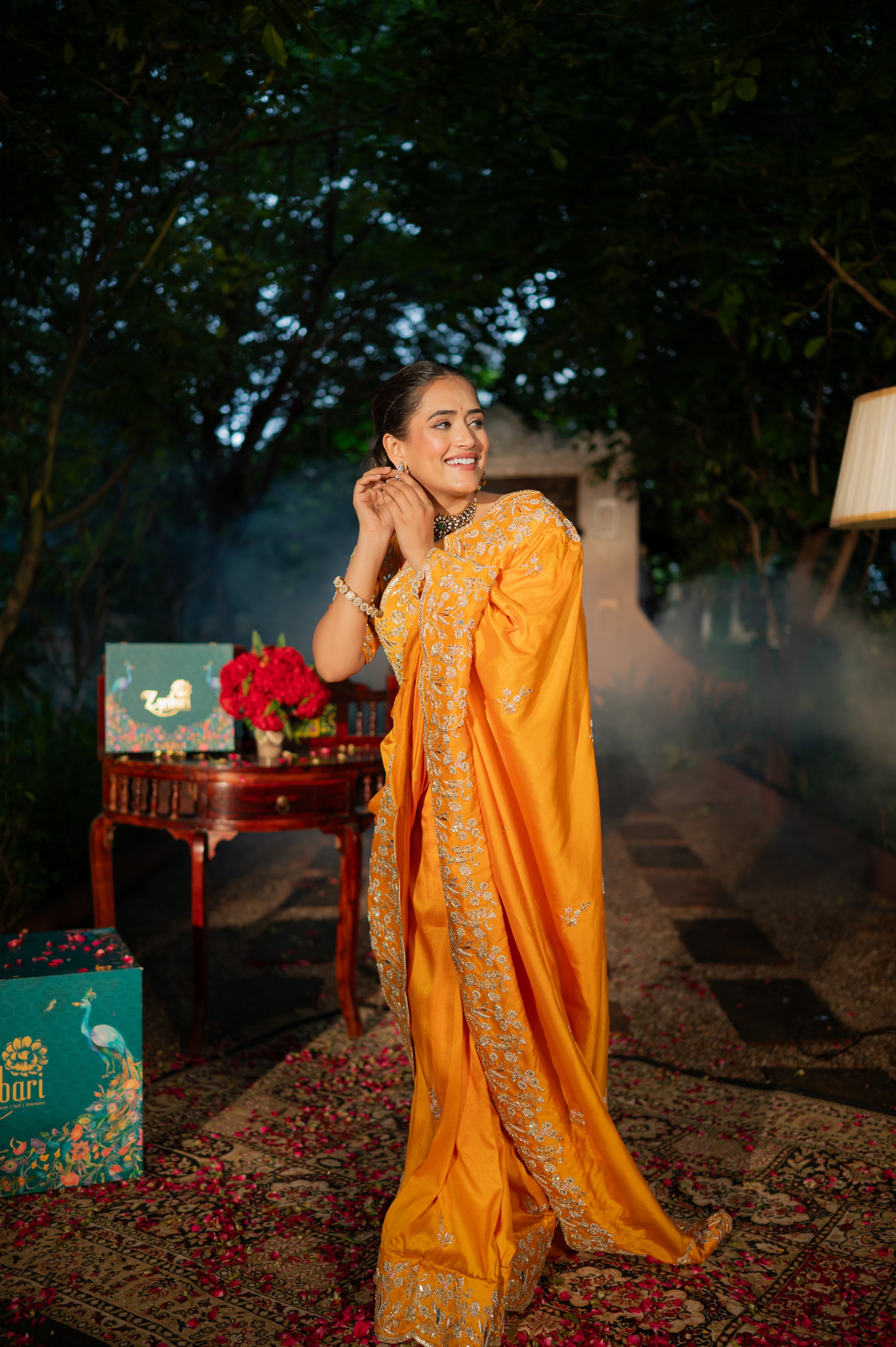 A stunning pumpkin orange pure silk saree featuring aari zardozi and pearl work saree beautifully adorned with fine craftsmanship and exquisite detailing, perfect for festive and special occasions.