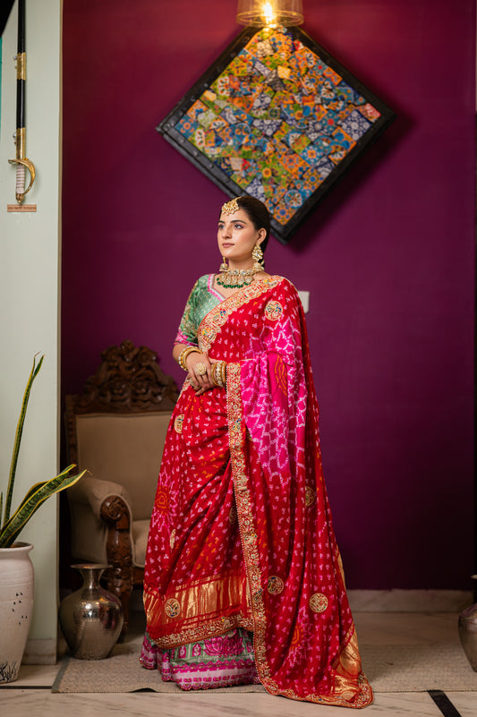 A stunning pink red gajji silk bandhej chunari featuring aari zardozi radha krishna peacock elephant dear motifs sequins work chunari beautifully adorned with fine craftsmanship and exquisite detailing, perfect for festive and special occasions.