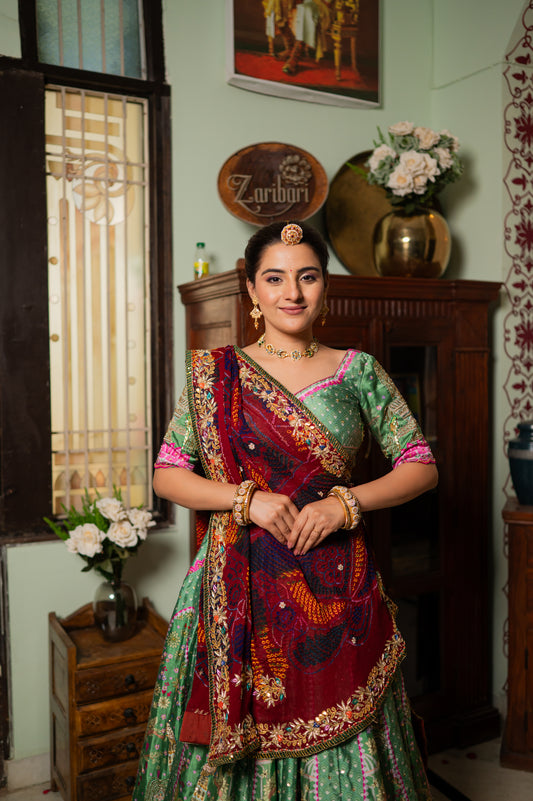 A stunning red pure ojariya bandhej chunari featuring zardozi gota patti sequins work chunari beautifully adorned with fine craftsmanship and exquisite detailing, perfect for festive and special occasions.