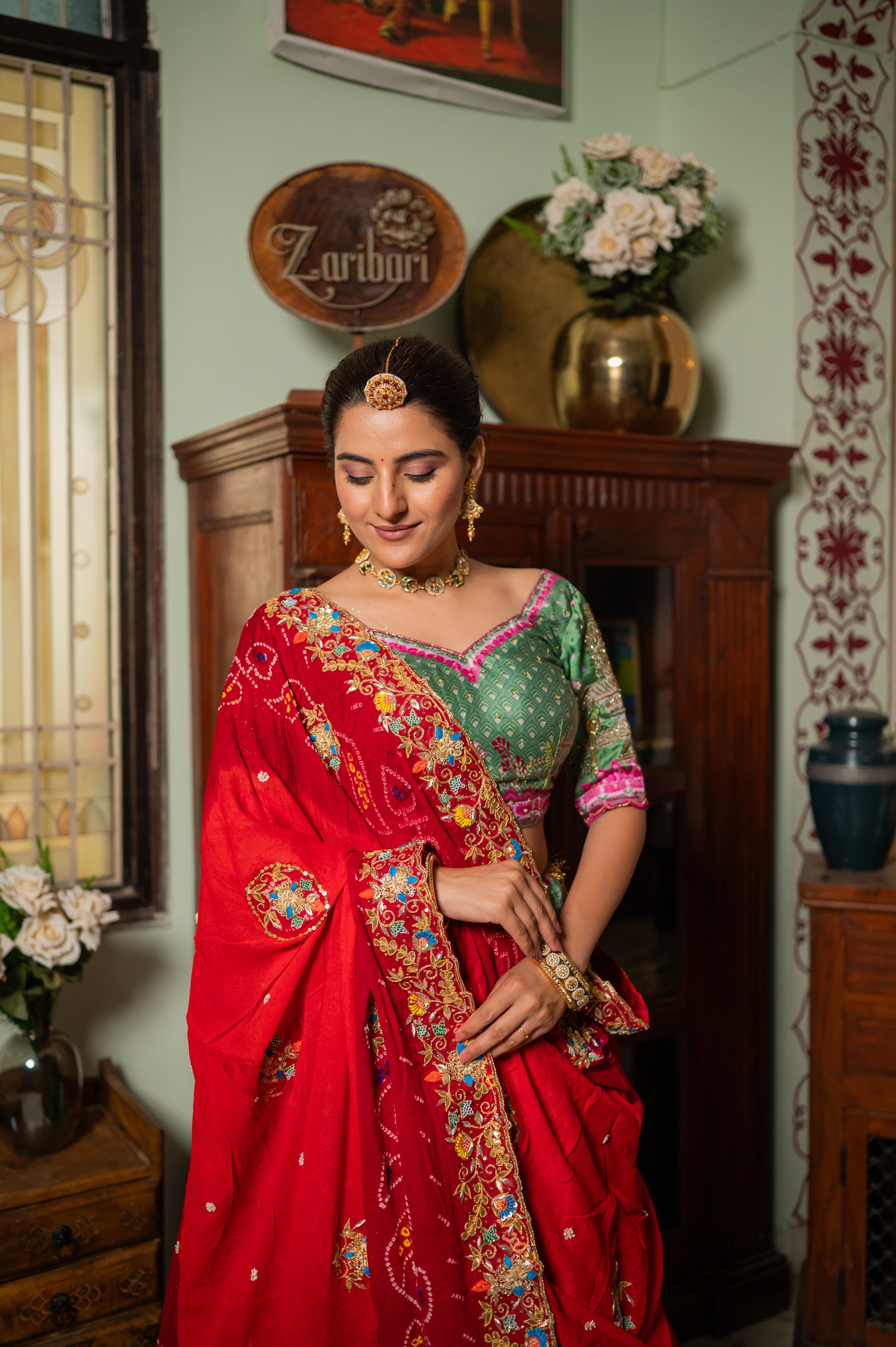 A stunning red pure ojariya bandhej chunari featuring zardozi gota patti thread sequins work chunari beautifully adorned with fine craftsmanship and exquisite detailing, perfect for festive and special occasions.