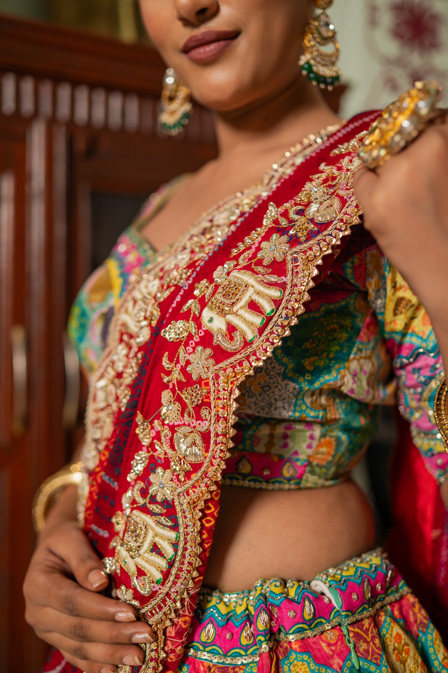 A stunning red pure ojariya bandhej chunari featuring marodi zardozi thread elephant motifs sequins work chunari beautifully adorned with fine craftsmanship and exquisite detailing, perfect for festive and special occasions.
