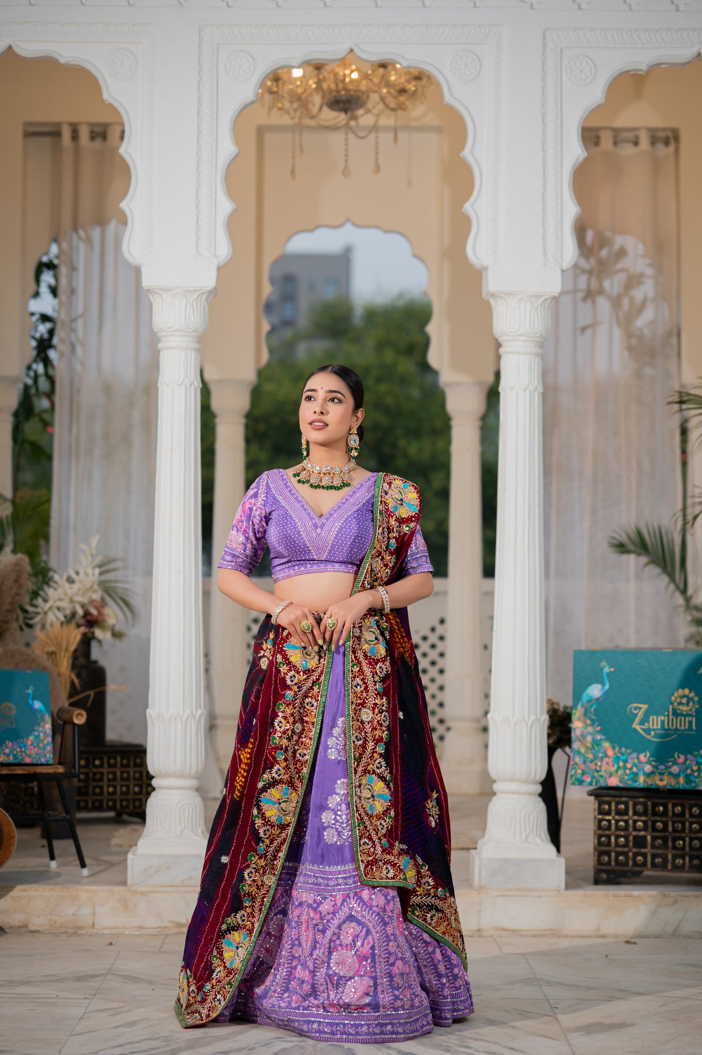 A stunning maroon pure ojariya bandhej chunari featuring zardozi sequins beads peacock motifs gota patti work chunari beautifully adorned with fine craftsmanship and exquisite detailing, perfect for festive and special occasions.