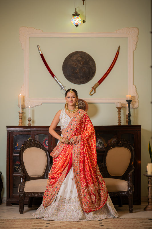 A stunning orange pure khaddi georgette meenakari bandhej chunari featuring thread kardana sequins work chunari beautifully adorned with fine craftsmanship and exquisite detailing, perfect for festive and special occasions.