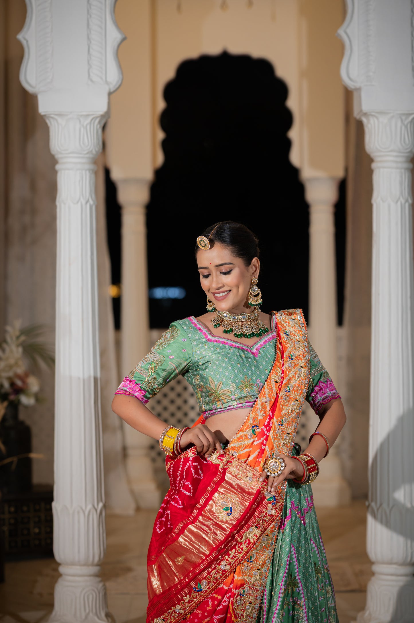 A stunning red orange gajji silk bandhej chunari featuring marodi zardozi and thread peacock elephant motifs sequins work chunari beautifully adorned with fine craftsmanship and exquisite detailing, perfect for festive and special occasions.