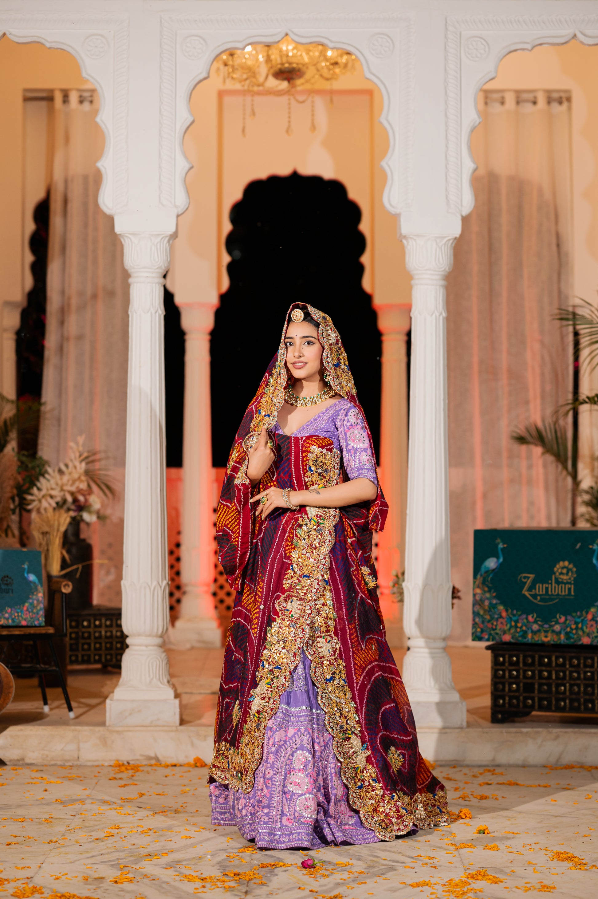 A stunning red pure ojariya bandhej chunari featuring marodi zardozi elephant motifs gota patti kardana work chunari beautifully adorned with fine craftsmanship and exquisite detailing, perfect for festive and special occasions.