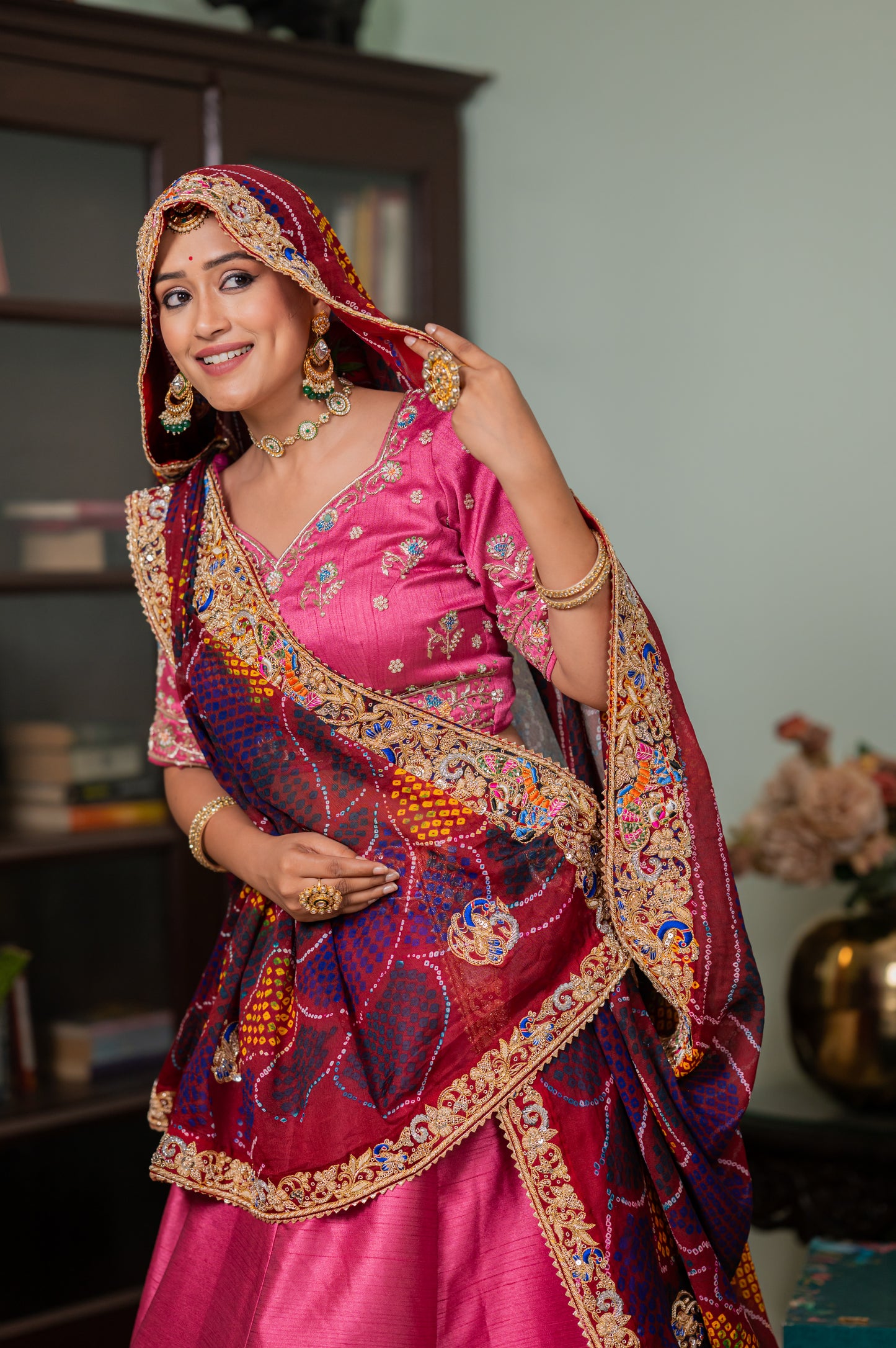 A stunning maroon pure ojariya bandhej chunari featuring zardozi radha yasodha motifs sequins work chunari beautifully adorned with fine craftsmanship and exquisite detailing, perfect for festive and special occasions.