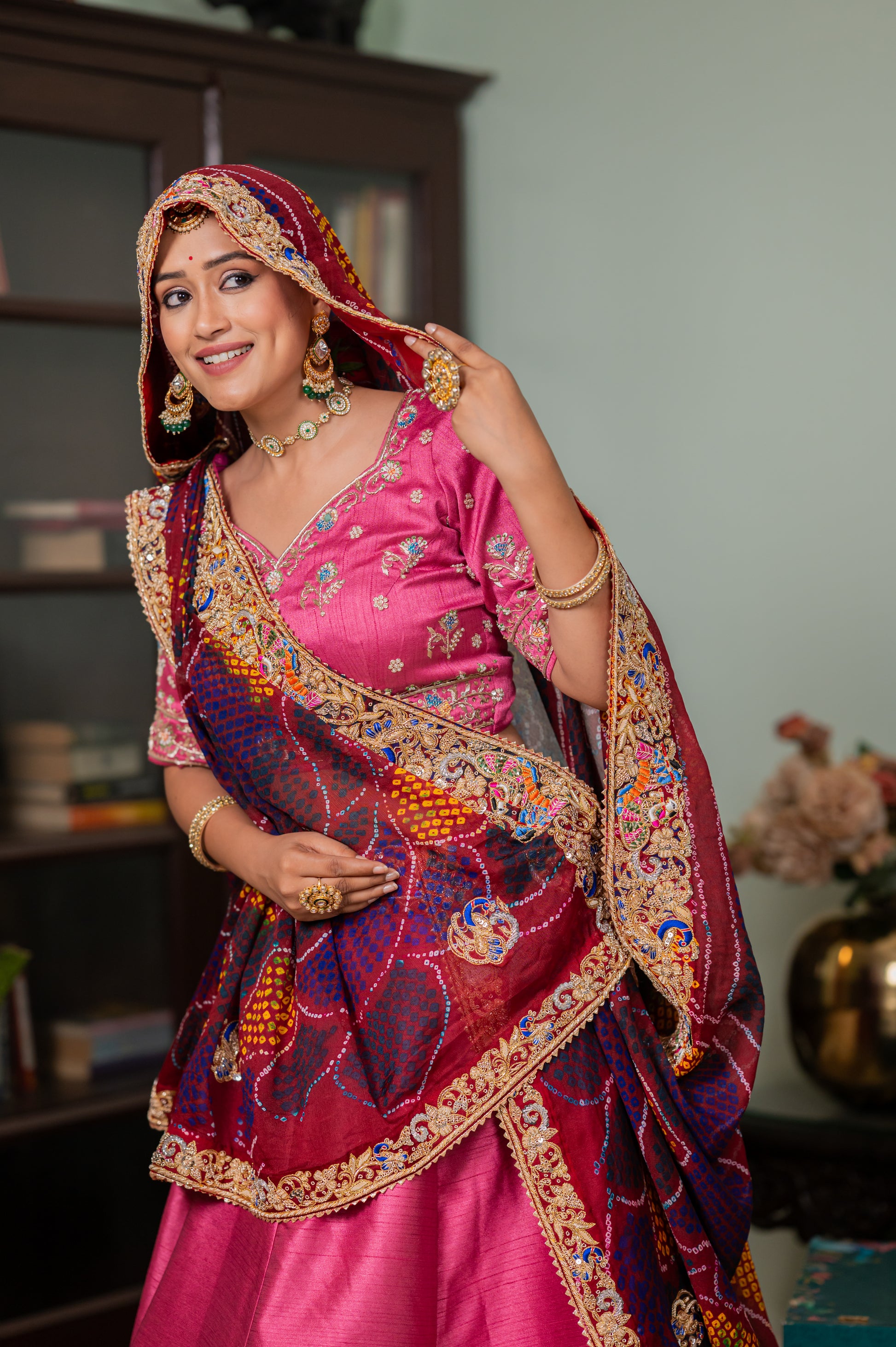 A stunning maroon pure ojariya bandhej chunari featuring zardozi radha yasodha motifs sequins work chunari beautifully adorned with fine craftsmanship and exquisite detailing, perfect for festive and special occasions.