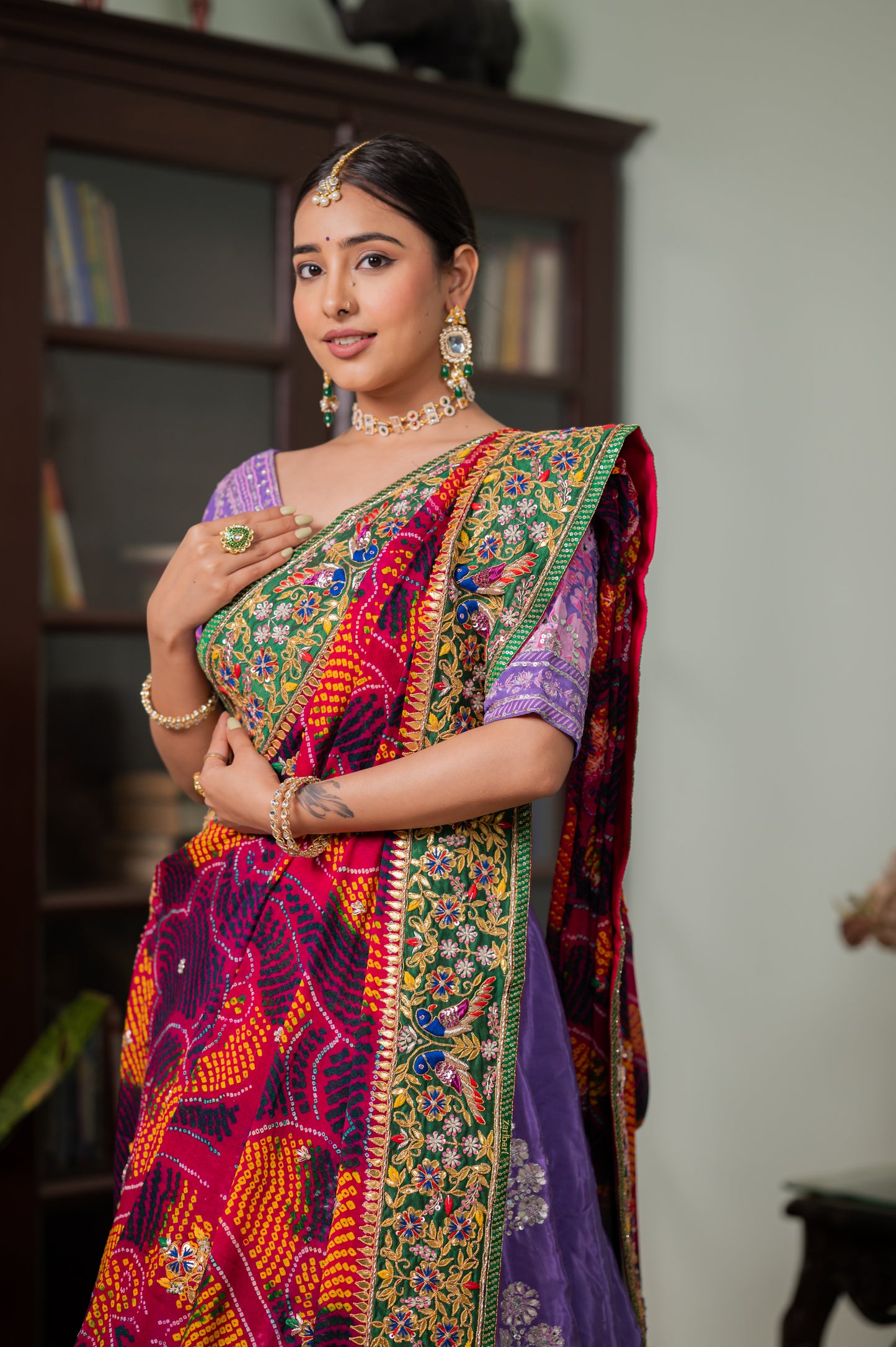 A stunning red pure ojariya bandhej chunari featuring zardozi gota patti double parrot motifs sequins work chunari beautifully adorned with fine craftsmanship and exquisite detailing, perfect for festive and special occasions.